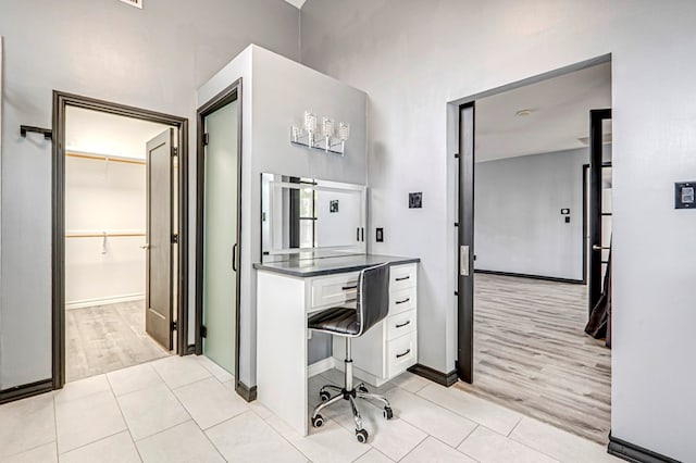 bathroom with baseboards and wood finished floors