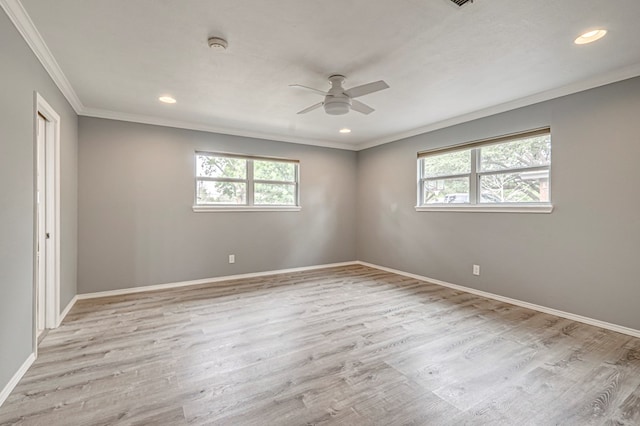 empty room with baseboards, ornamental molding, ceiling fan, and a healthy amount of sunlight