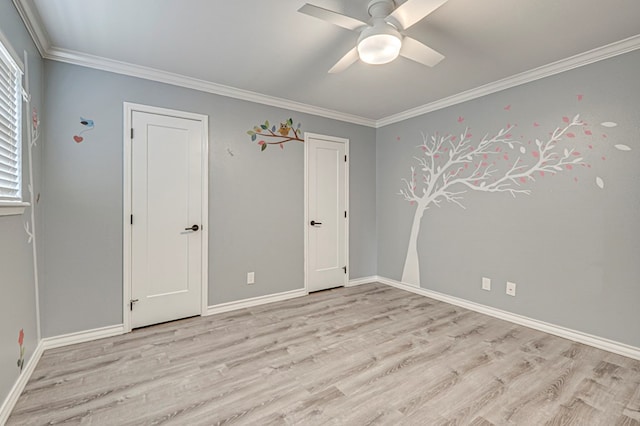 unfurnished room with crown molding, a ceiling fan, baseboards, and light wood-style floors