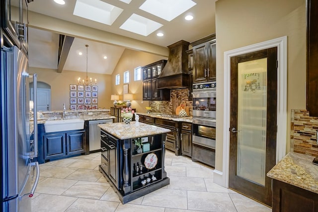5319 Half Moon Cir, Midland, TX 79707 - kitchen with stainless steel appliances, a sink, custom exhaust hood, a chandelier, and decorative backsplash