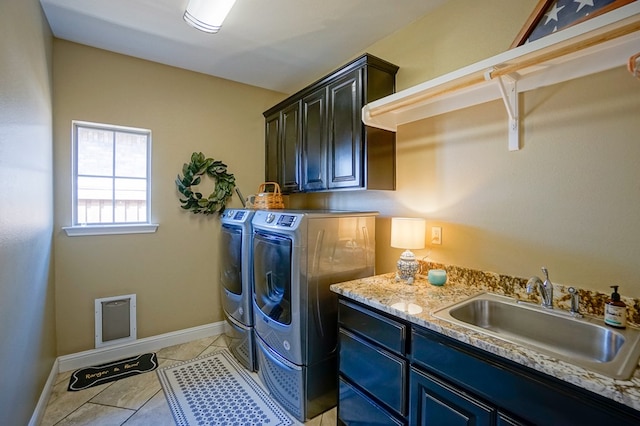 5319 Half Moon Cir, Midland, TX 79707 - washroom with independent washer and dryer, cabinet space, baseboards, and light tile patterned floors
