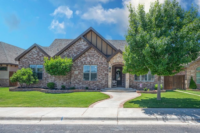5319 Half Moon Cir, Midland, TX 79707 - view of front of house featuring brick siding, board and batten siding, and a front lawn
