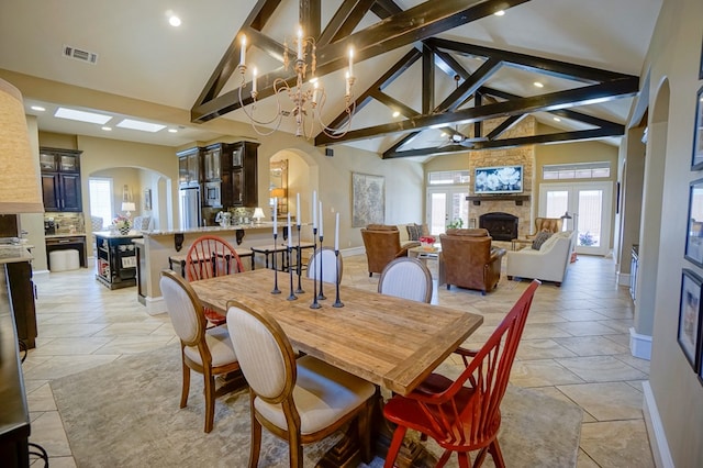 5319 Half Moon Cir, Midland, TX 79707 - dining area featuring arched walkways, baseboards, a fireplace, a ceiling fan, and recessed lighting
