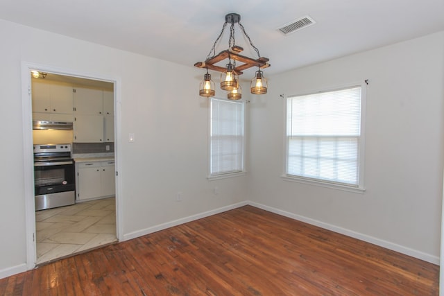 unfurnished dining area with wood-type flooring