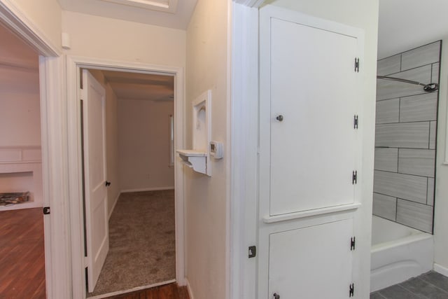 bathroom with wood-type flooring and tiled shower / bath