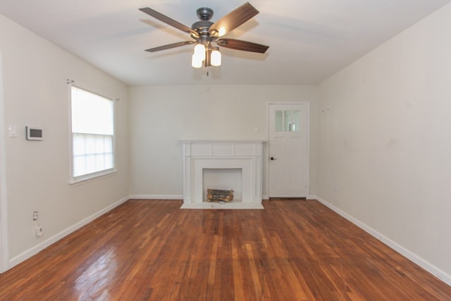 unfurnished living room featuring ceiling fan and dark wood-type flooring