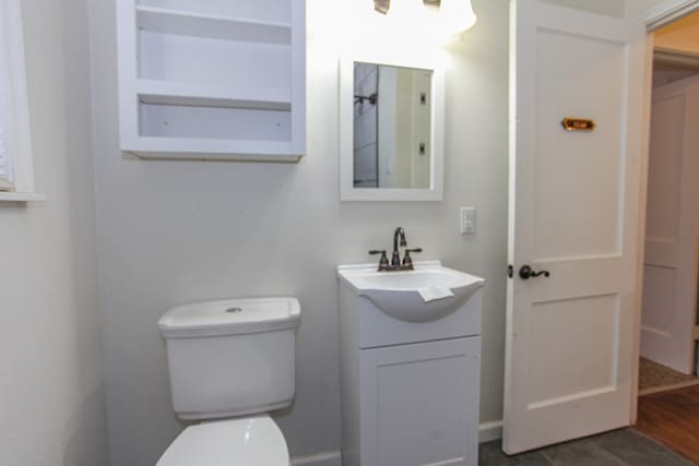 bathroom featuring vanity, toilet, and hardwood / wood-style floors