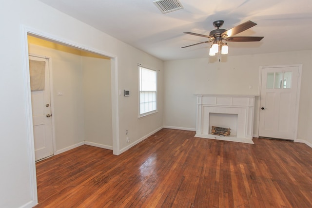 unfurnished living room with ceiling fan and dark hardwood / wood-style flooring