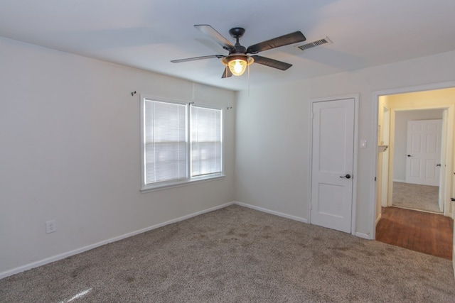 spare room featuring carpet floors and ceiling fan