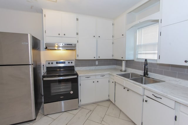 kitchen with sink, backsplash, white cabinets, and appliances with stainless steel finishes