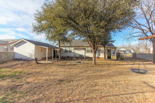 back of house with a lawn