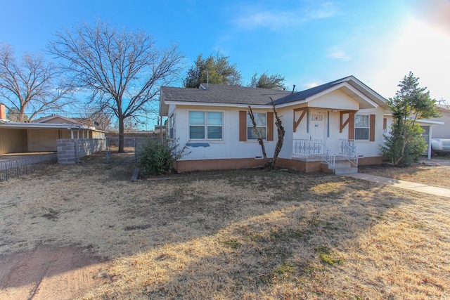 ranch-style home with a front lawn