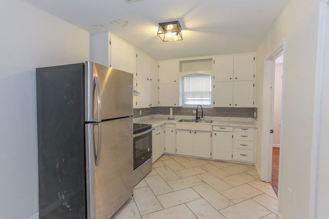 kitchen with sink, white cabinetry, appliances with stainless steel finishes, and tasteful backsplash