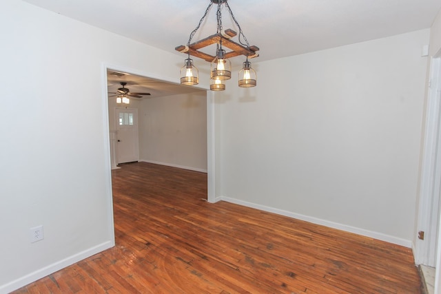 unfurnished room with dark wood-type flooring