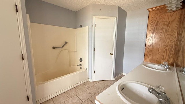 bathroom with shower / bath combination, a sink, a textured ceiling, and tile patterned floors