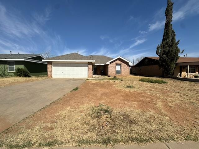 single story home featuring a garage, concrete driveway, and brick siding