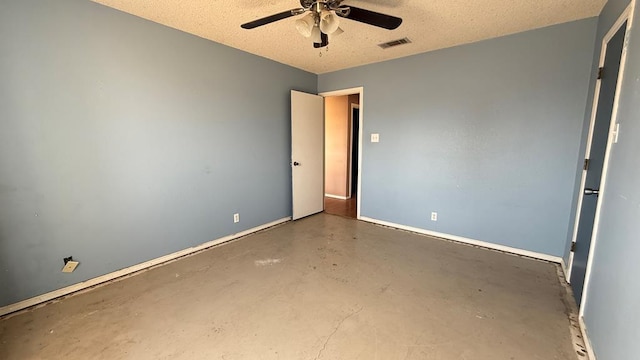 unfurnished room featuring ceiling fan, concrete floors, visible vents, and a textured ceiling