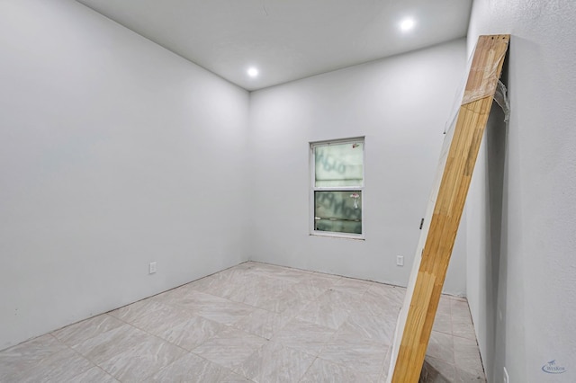 unfurnished room with recessed lighting