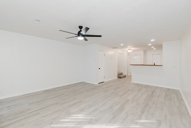 unfurnished living room featuring ceiling fan and light hardwood / wood-style flooring