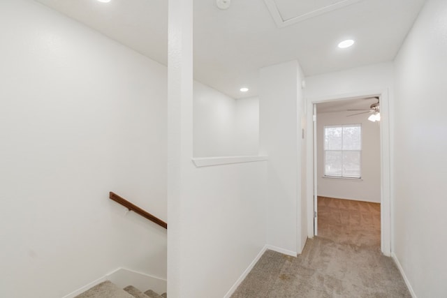 hallway with light colored carpet