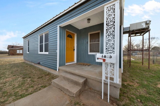 doorway to property featuring a lawn