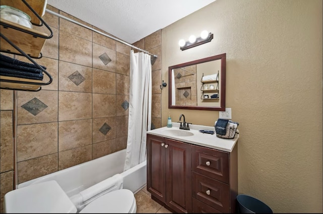 bathroom with toilet, shower / bathtub combination with curtain, vanity, and a textured wall