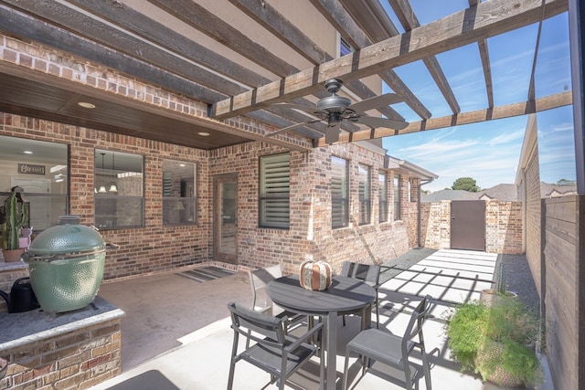 view of patio / terrace featuring area for grilling, ceiling fan, and a pergola