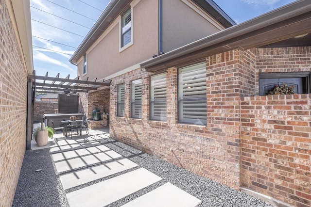 view of side of property with a pergola and a patio