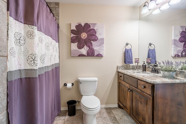 bathroom with vanity, tile patterned floors, and toilet