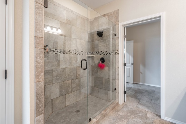 bathroom featuring a shower with door