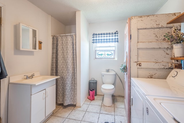 6308 S County Rd 1182, Midland, TX 79706 - bathroom with vanity, toilet, a textured ceiling, washing machine and clothes dryer, and tile patterned floors