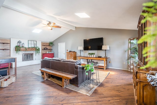 6308 S County Rd 1182, Midland, TX 79706 - living area featuring lofted ceiling with beams, ceiling fan, wood finished floors, and a brick fireplace
