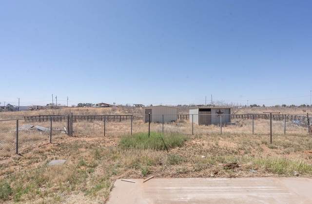 6308 S County Rd 1182, Midland, TX 79706 - view of yard featuring an outbuilding, fence, and a rural view