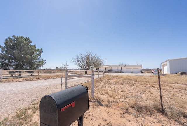 6308 S County Rd 1182, Midland, TX 79706 - view of yard featuring a detached garage, fence, and a rural view
