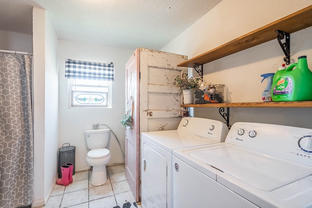 6308 S County Rd 1182, Midland, TX 79706 - clothes washing area featuring light tile patterned flooring, independent washer and dryer, laundry area, and a textured ceiling