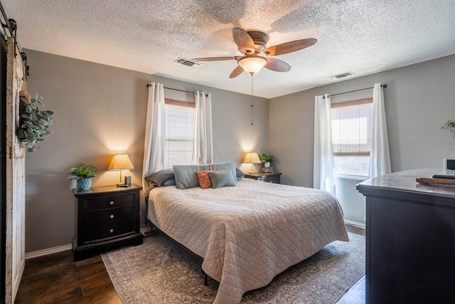 6308 S County Rd 1182, Midland, TX 79706 - bedroom featuring dark wood-type flooring, baseboards, ceiling fan, and visible vents