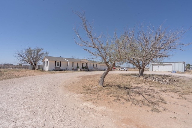 6308 S County Rd 1182, Midland, TX 79706 - single story home featuring a detached garage, an outbuilding, and dirt driveway