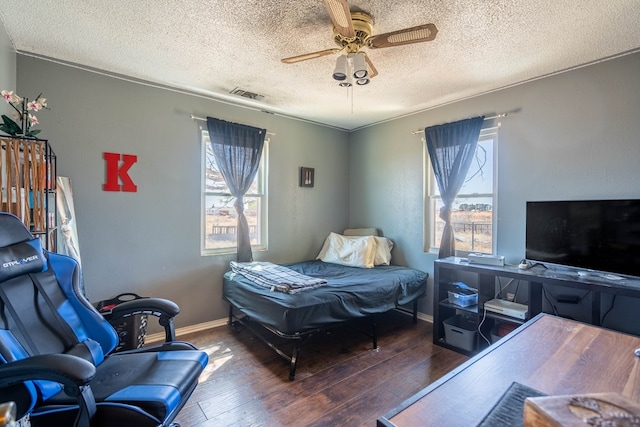 6308 S County Rd 1182, Midland, TX 79706 - bedroom with multiple windows, visible vents, hardwood / wood-style flooring, and a ceiling fan