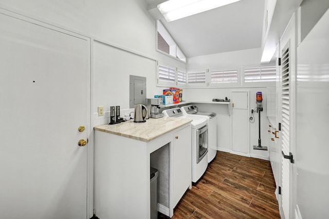 laundry room with dark wood-style flooring, independent washer and dryer, a towering ceiling, and electric panel