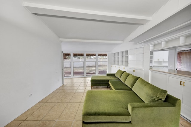 living room featuring light tile patterned flooring and vaulted ceiling with beams