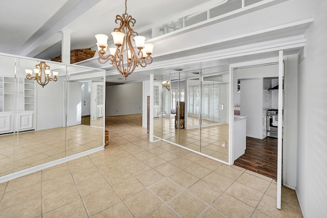 interior space featuring a chandelier, beam ceiling, and built in shelves