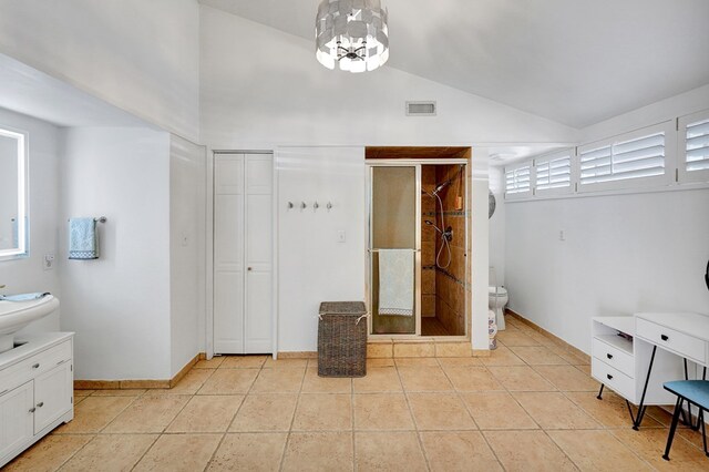 full bath featuring vaulted ceiling, tile patterned flooring, a shower stall, and visible vents