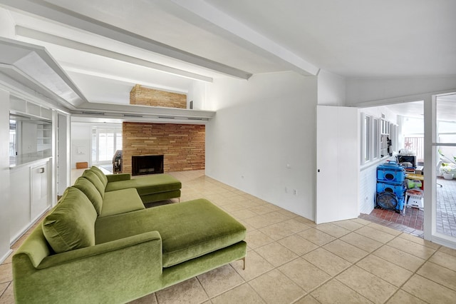 living area featuring vaulted ceiling with beams, a fireplace, and light tile patterned floors