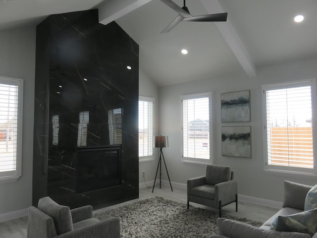 living room with lofted ceiling with beams, hardwood / wood-style flooring, and ceiling fan