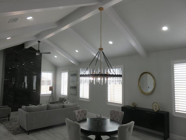 dining area featuring lofted ceiling with beams and ceiling fan