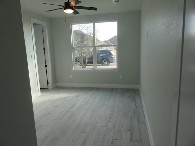 unfurnished room with ceiling fan and light hardwood / wood-style floors