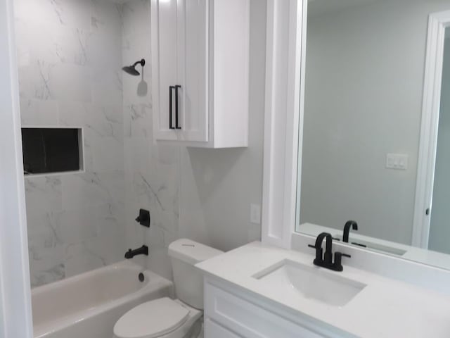 full bathroom featuring toilet, vanity, and tiled shower / bath