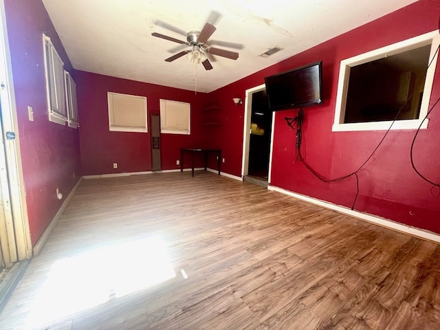 spare room with hardwood / wood-style floors and ceiling fan