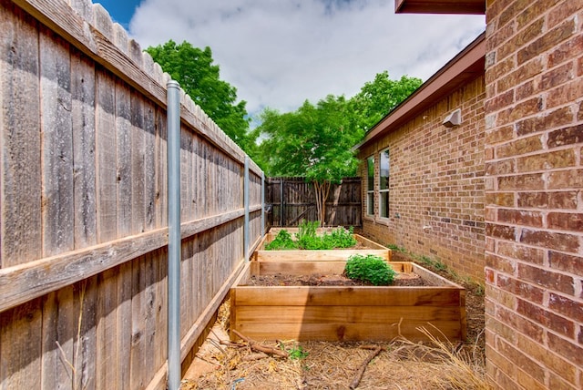 view of yard featuring a vegetable garden and a fenced backyard