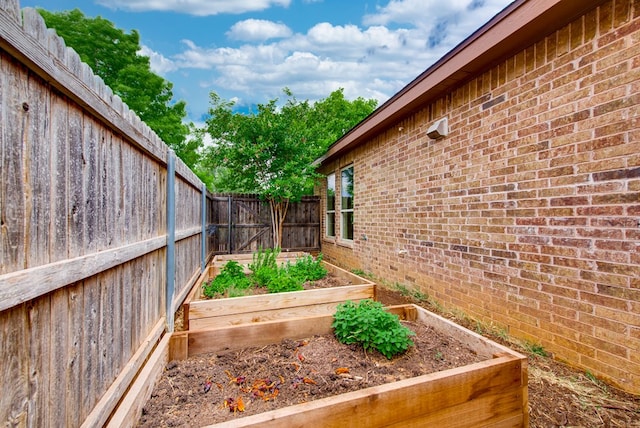 view of yard featuring a vegetable garden and a fenced backyard